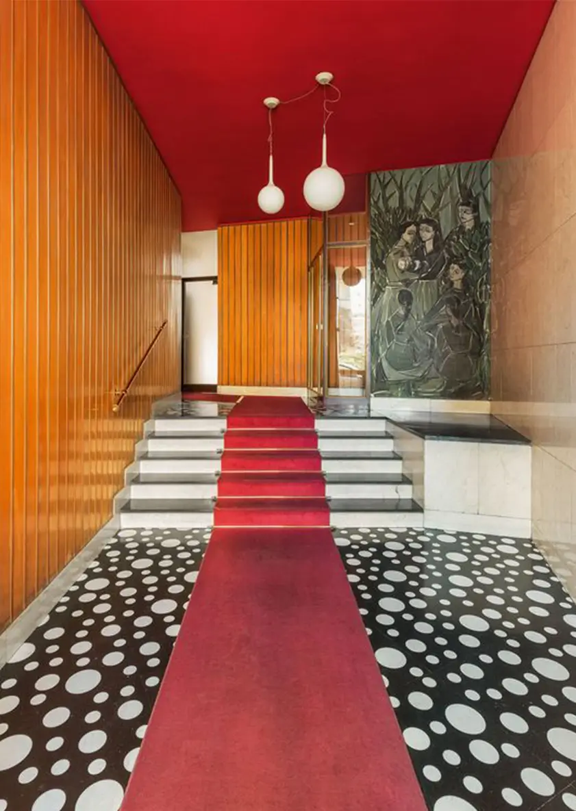 new maximalism of richly layered mixture of finishes in hallway