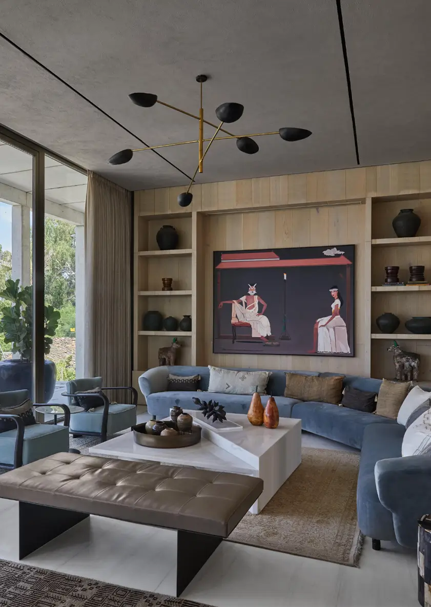 Contemporary reception with curved sofa upholstered in soft blue velvet